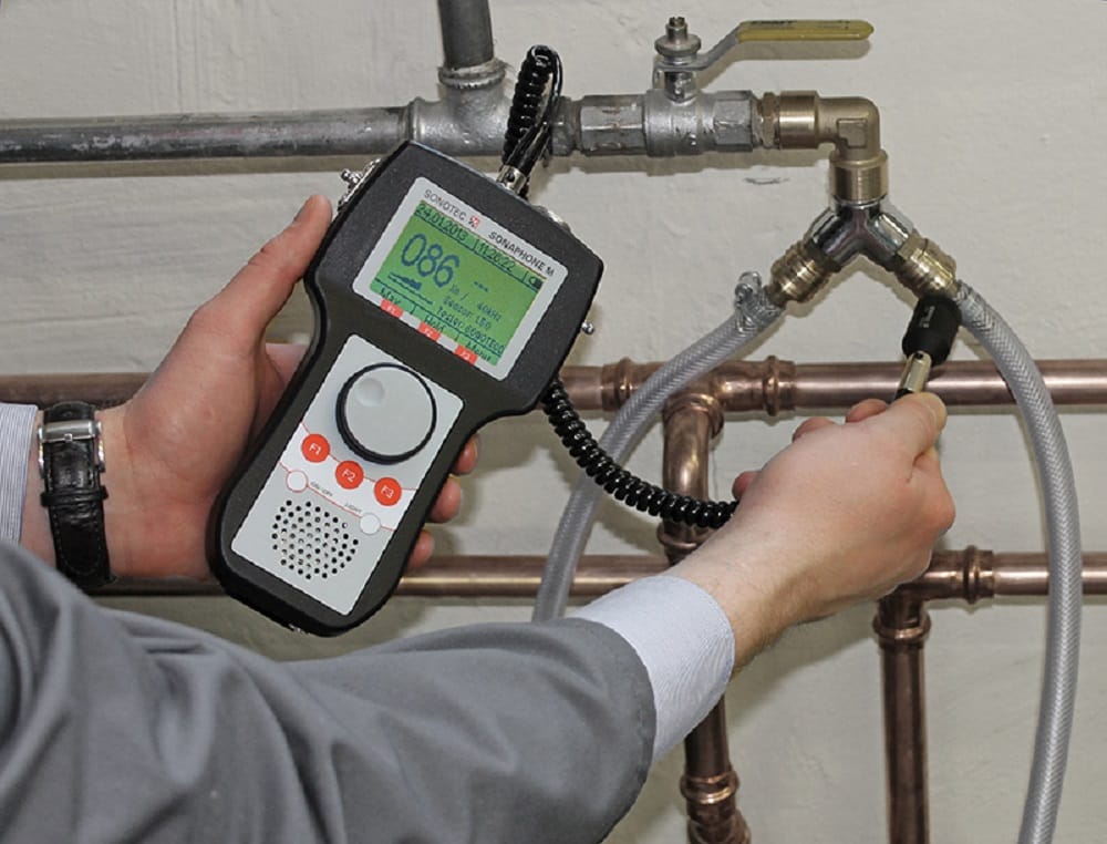 Plumber testing pipes with electronic leak detection equipment in Crestview