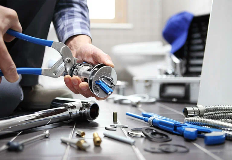 Technician repairing a plumbing fixture with professional tools in Crestview