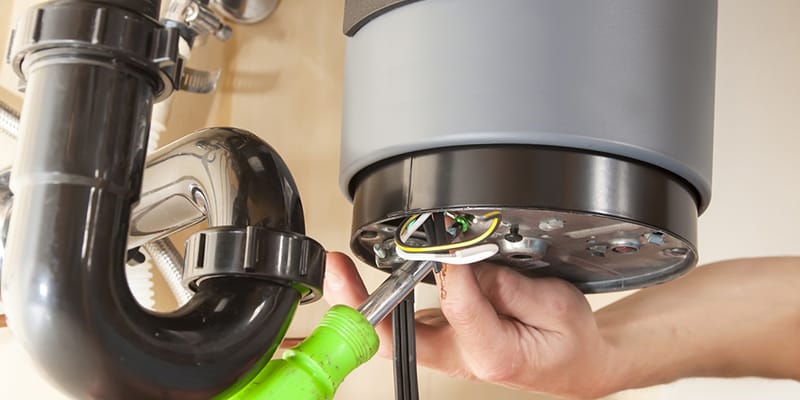 Technician repairing the heating element of a water heater in Crestview