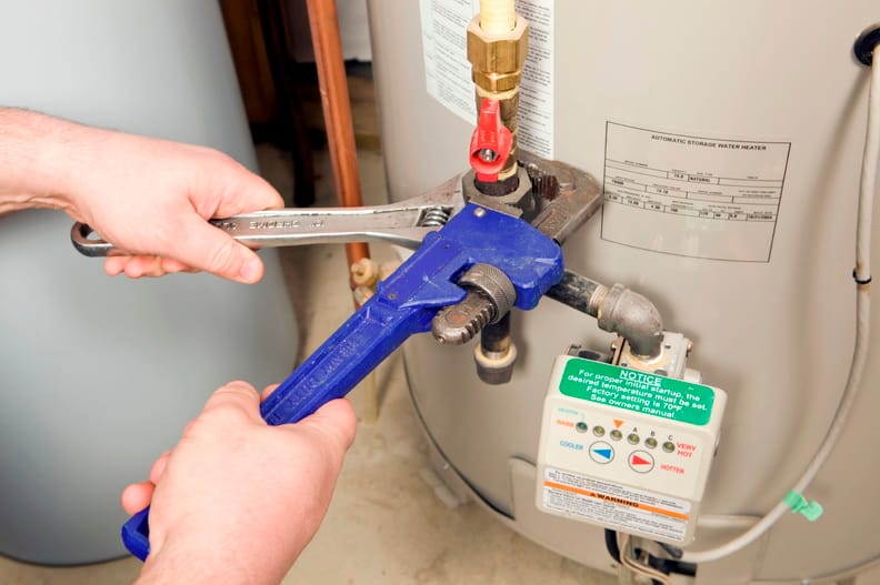 Plumber repairing a water heater valve in Crestview